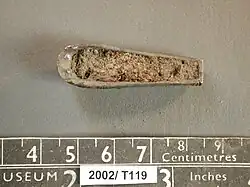 Colour photograph of the bottom of the Horncastle helmet fragment, showing that it is hollow and filled with dirt