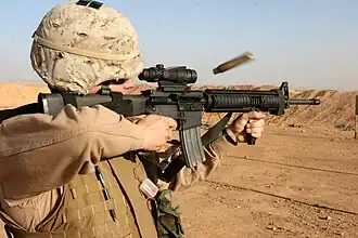 USMC-spec M16A4 fitted with ACOG, vertical foregrip, and AN/PVQ-31