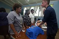 Aboard the Military Sealift Command (MSC) hospital ship, USNS Mercy, YN3 Dan S. Konzek demonstrates how to properly locate the carotid pulse to nurses from the Modilion General Hospital in Madang, Papua, New Guinea. USNS Mercy had just completed tsunami and earthquake relief operations in Indonesia (2005).