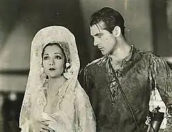 Black and white film still showing Lupe Vélez in wedding attire and Gary Cooper in Western attire from the 1929 film Wolf Song