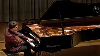 Pianist Vadim Chaimovich performing on a Bösendorfer grand piano on the stage of the Onoldia Concert Hall in Ansbach, Germany, on October 22, 2015