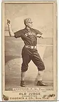 Standing man in baseball uniform throwing ball