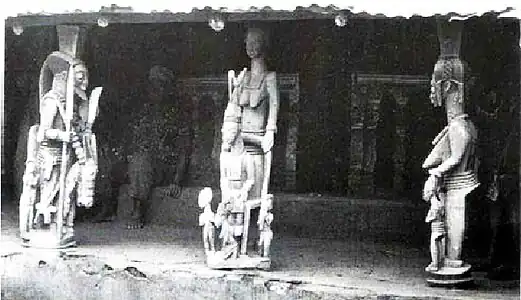 Veranda entrance posts (Opo Ogoga) depicting a royal horseman, a woman with twin daughters from Ikere-Ekiti.