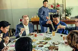 A meal being eaten during a state visit of Hungary to China inside a people's commune during meal hour.