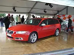 Front drivers side view of red V70 R-Design with matte silver trim, mirror caps and foglight surrounds