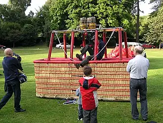 Preparing for flight: This large wicker balloon basket holds 16 passengers. The pilot is climbing out after his pre-flight tests