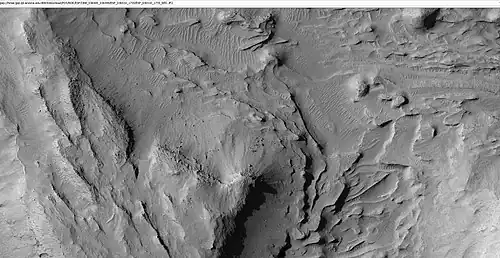 Mound showing layers at the base, as seen by HiRISE under HiWish program. Location is east of Gale Crater in the Aeolis quadrangle.