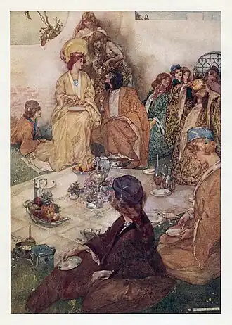 Elaborate illustration showing the character Hilarion, disguised as a woman, speaking to Princess Ida during an outdoor picnic. Ida wears a crown and is seated on a chair; in the middle of the image, Hilarion crouches beside her to her left, with two of his friends to his left, also disguised as women. Several other women are seated around a picnic blanket on grassy ground with a brick wall in the background, all wearing academic robes; two women, dressed as medieval peasants, are serving the diners from above and behind.